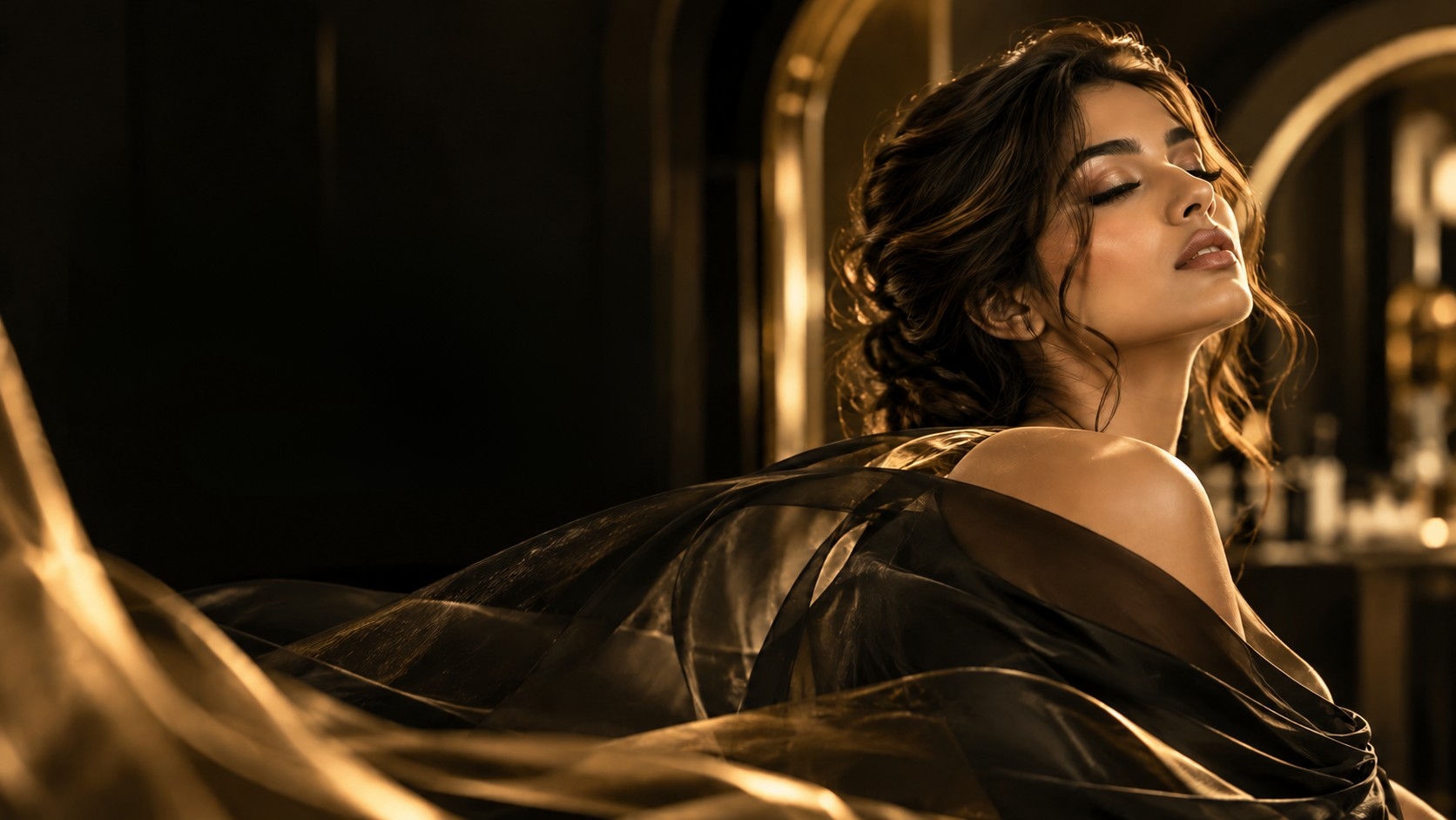 A woman in a sheer gold drape, eyes closed, in warm low light. Editorial photograph, not the Leviosa interior.